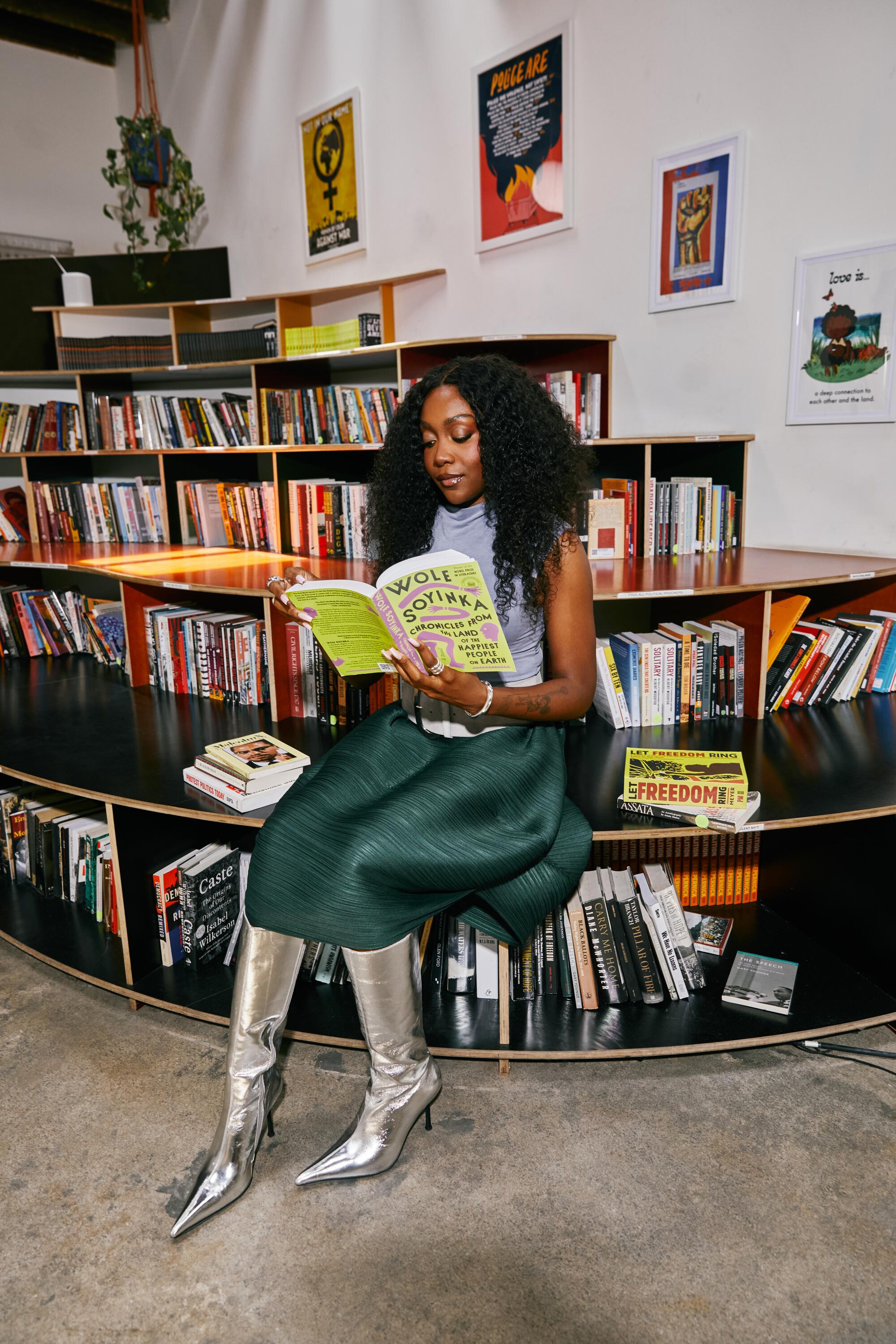 Noname wears Paloma Wool top and belt, Pleats Please by Issey Miyake skirt, Jeffrey Campbell shoes