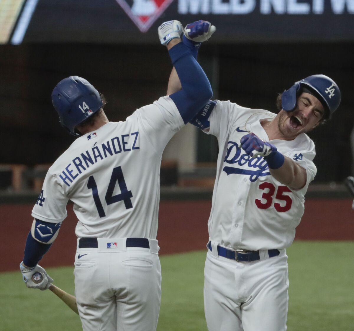 Dodgers' Cody Bellinger, right, celebrates with teammate Kiké Hernández after hitting a home run 