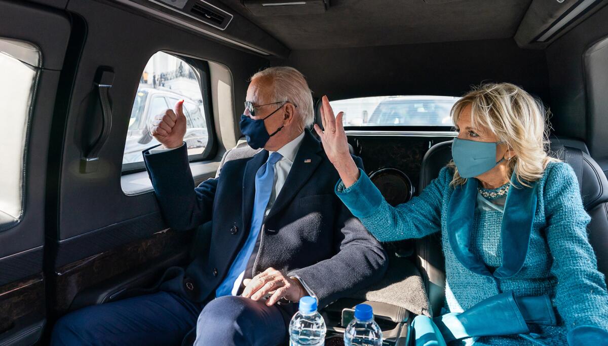 President Biden and First Lady Jill Biden wave as they ride in the presidential limousine Jan. 20. 