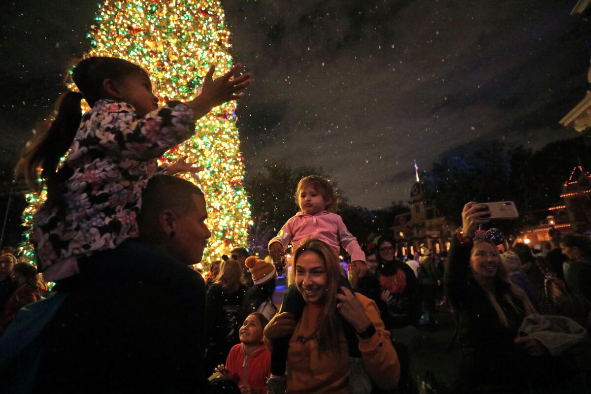 A couple and their children enjoy the falling snow on Main Street on Nov. 19, 2019. 