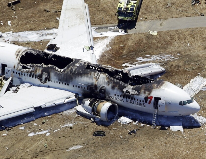 The charred wreckage of the Asiana Airlines flight from South Korea lies at the San Francisco International Airport after it crashed during landing.
