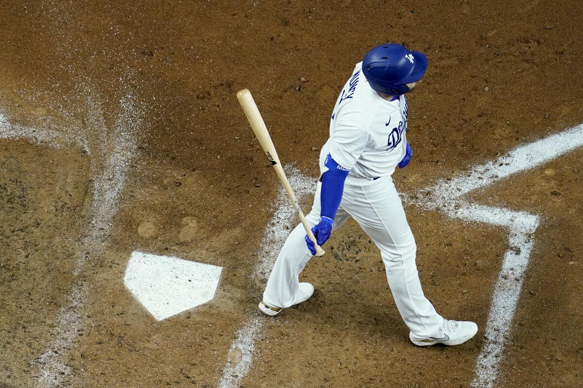 Max Muncy walks away from the plate after striking out during the third inning of the Dodgers' 5-1 loss.