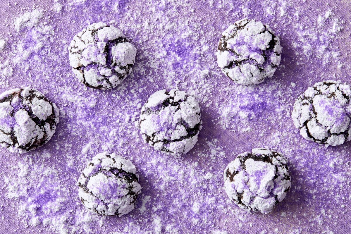 Funky maca root powder lends its malted milk-like flavor to these chewy rich chocolate crinkle cookies, coated in pale purple powdered sugar.