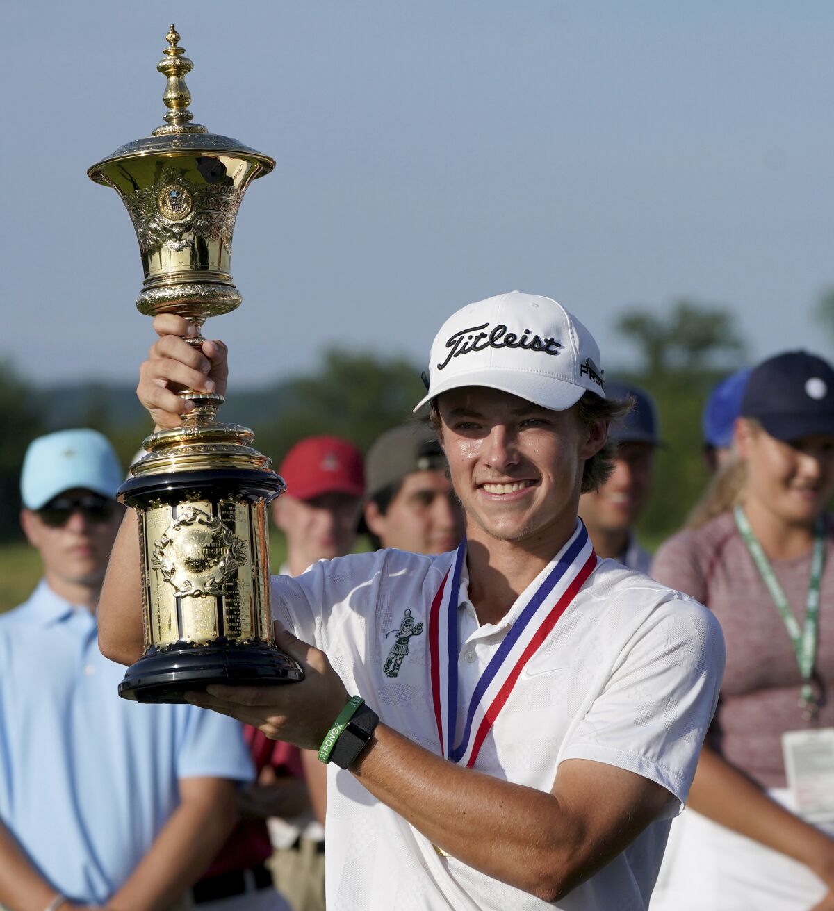 James Piot lifts the trophy after defeating Austin Greaser on the 17th hole to win the U.S. Amateur Championship golf tournament Sunday, Aug. 15, 2021, at Oakmont Country Club in Oakmont, Pa. (Matt Freed/Pittsburgh Post-Gazette via AP)