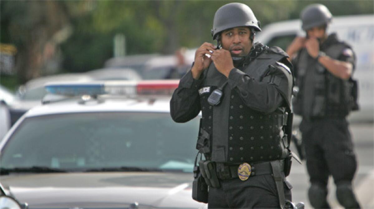 Police prepare to search a neighborhood for suspects after a Gardena police officer was shot.