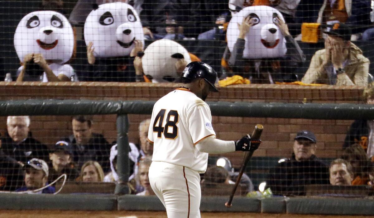 Giants fans wearing panda heads react after Pablo Sandoval, the "Kung Fu Panda," struck out in the third inning of Game 4 of the World Series.