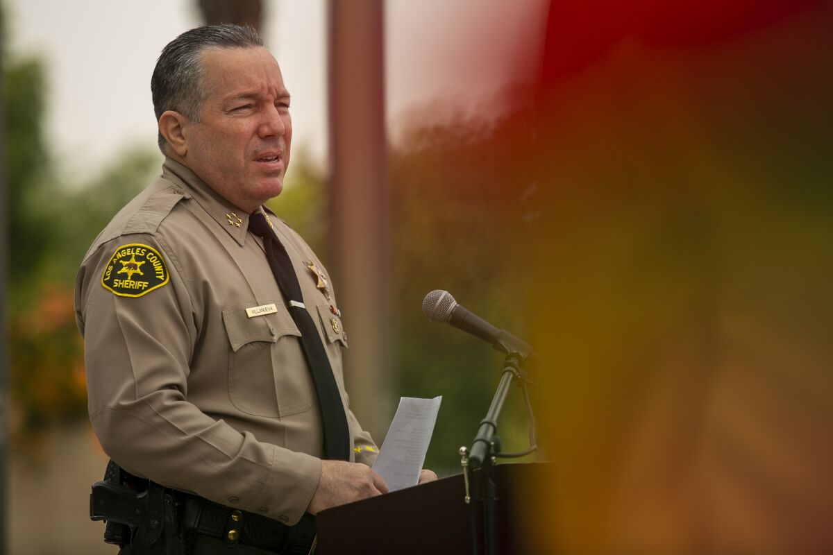 Los Angeles County Sheriff Alex Villanueva speaks at a lectern during a press conference