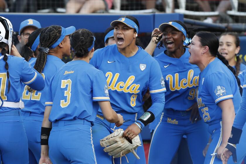UCLA pitcher Megan Faraimo (8) and her teammates are fired up after Faraimo got out of a fifth-inning jam June 3, 2022.