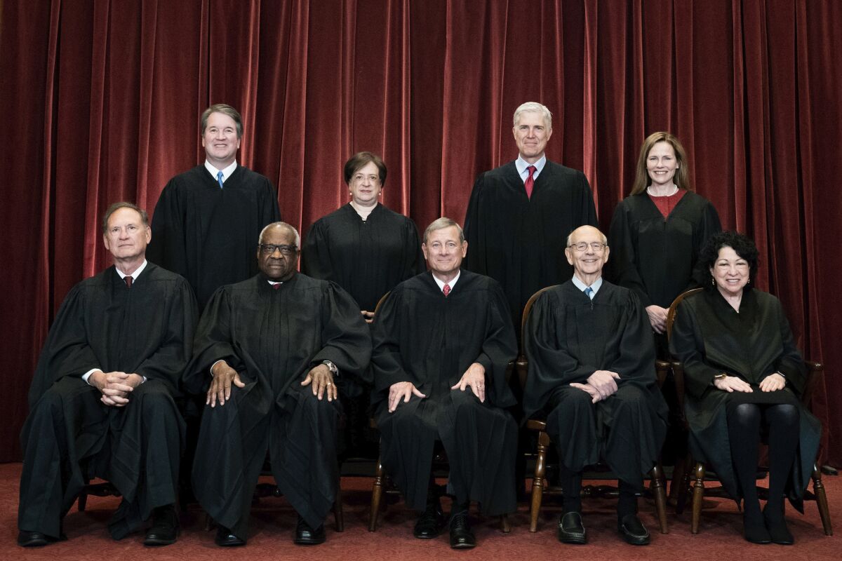 FILE - Members of the Supreme Court pose for a group photo at the Supreme Court in Washington, April 23, 2021. Seated from left are Associate Justice Samuel Alito, Associate Justice Clarence Thomas, Chief Justice John Roberts, Associate Justice Stephen Breyer and Associate Justice Sonia Sotomayor, Standing from left are Associate Justice Brett Kavanaugh, Associate Justice Elena Kagan, Associate Justice Neil Gorsuch and Associate Justice Amy Coney Barrett. The Supreme Court says it will continue providing live audio broadcasts of arguments in cases, even as it welcomes the public back to its courtroom for a new term that begins Monday. (Erin Schaff/The New York Times via AP, Pool)