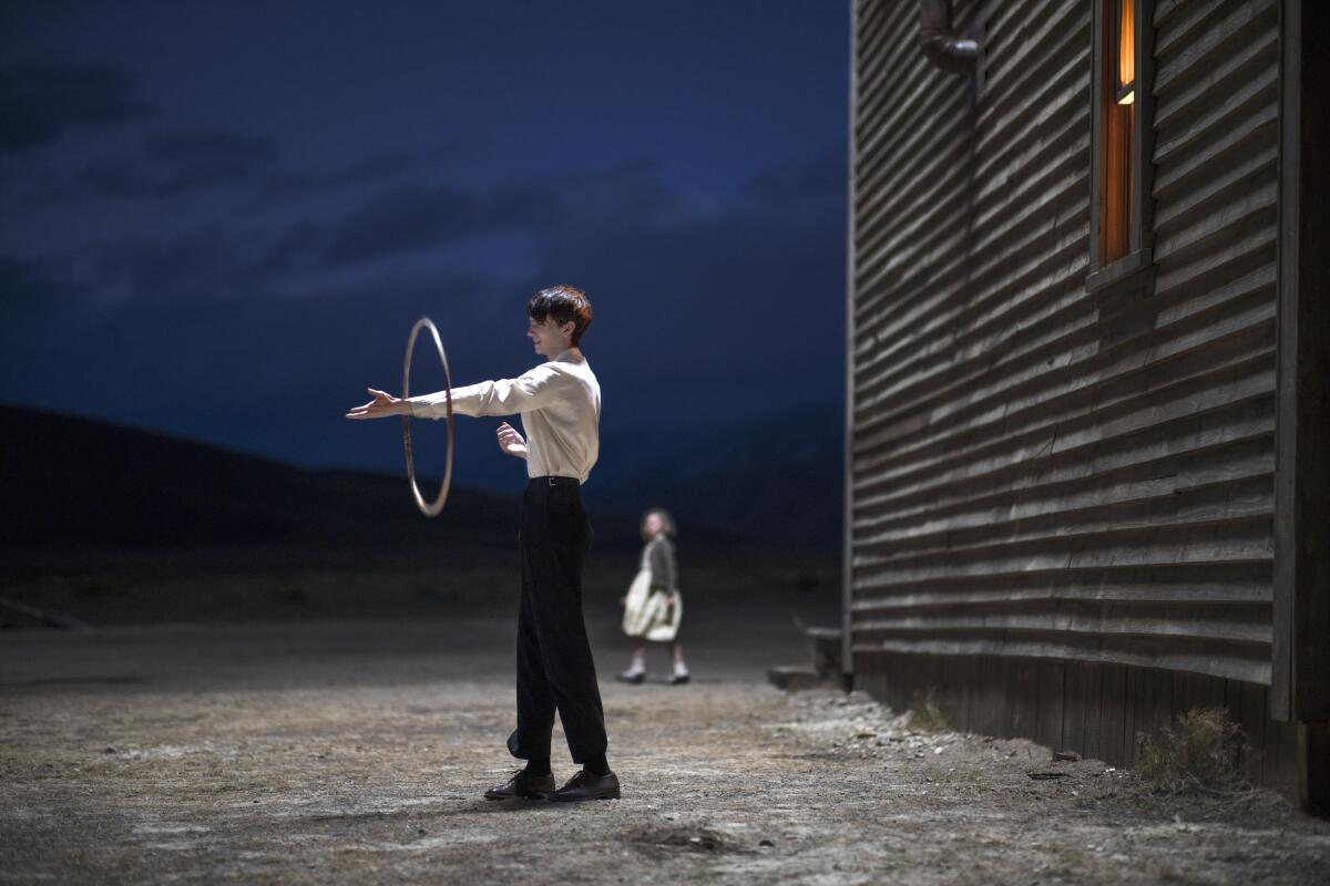 Kodi Smit-Mcphee twirls a hoop around his arm in "The Power of the Dog."