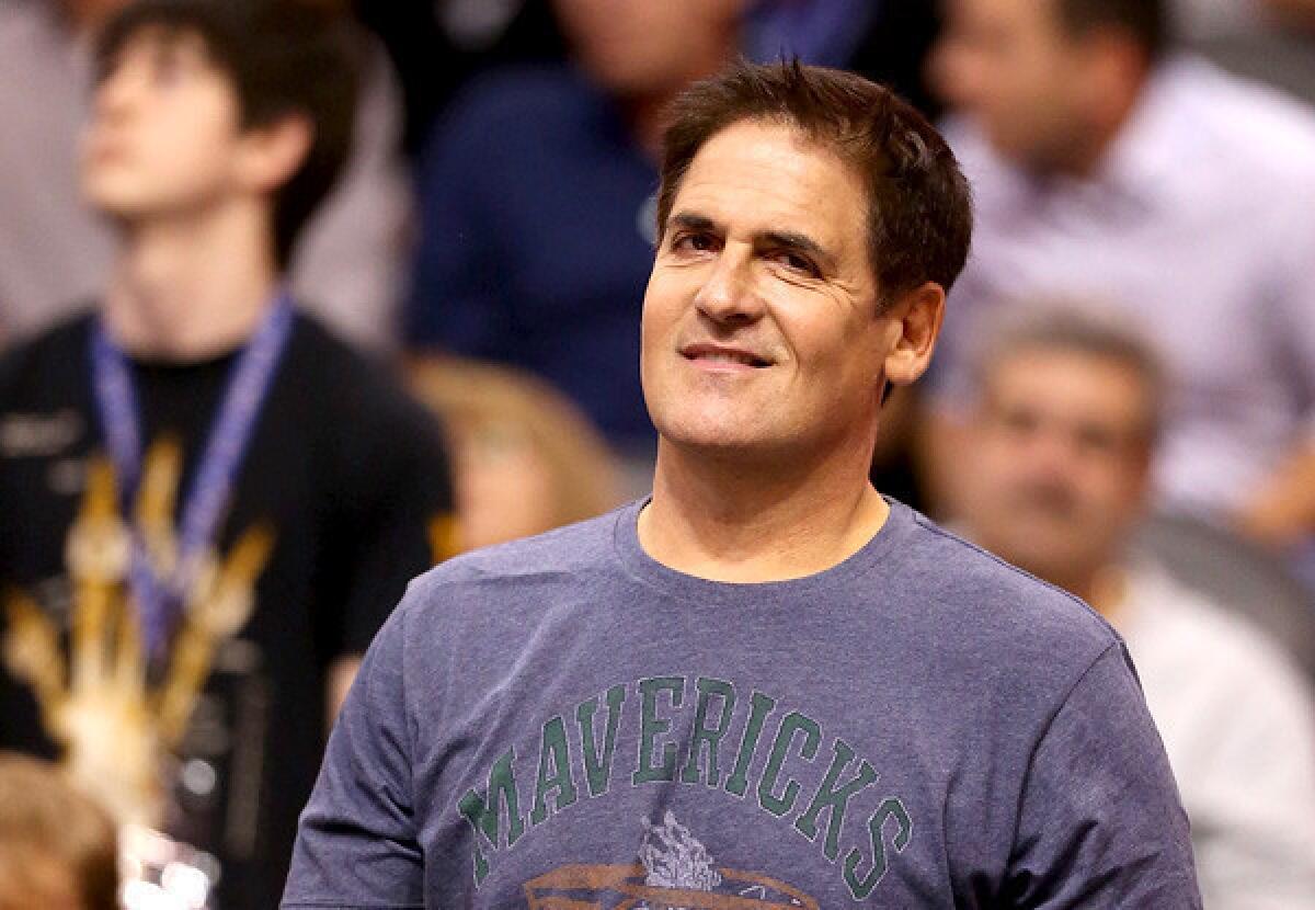 Mavericks owner Mark Cuban watches his club defeat the Suns, 110-107, on Friday in Phoenix.