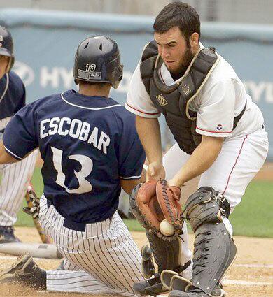 Chatsworth's Carlos Escobar Jr. beats the throw to Cleveland catcher Spencer Horowitz to score the game's first run on a single by Sean O'Connell in the City Section Division I championship game on Saturday at Dodger Stadium.