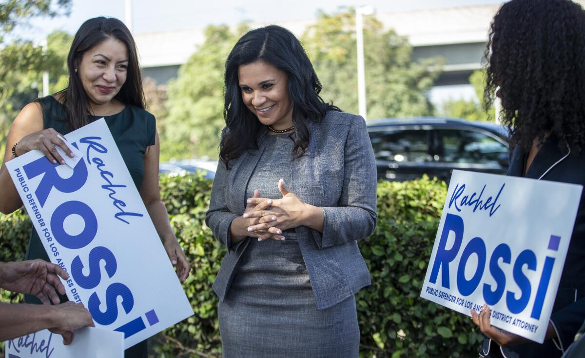 Rachel Rossi, center, chats with supporters shortly before announcing her entry into the Los Angeles County district attorney's race.