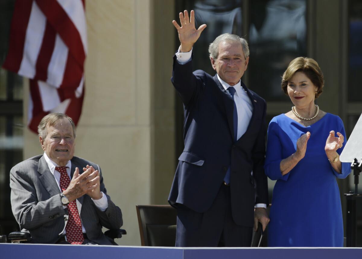 Former President George H.W. Bush, left, former President George W. Bush and former First Lady Laura Bush at the dedication of the George W. Bush Presidential Center in Dallas in 2013.