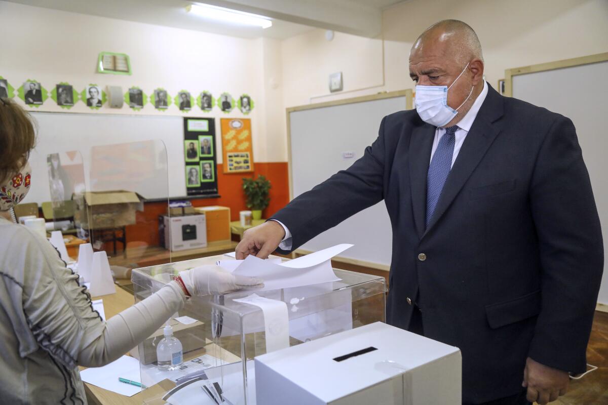 In this photo released by the GERZB Party, Bulgarian Prime Minister Boyko Borissov casts his ballot during parliamentary elections in the town of during the parliamentary elections in the town of Bankya, Bulgaria, Sunday, April 4, 2021. Bulgarians are heading to the polls on Sunday to cast ballots for a new parliament after months of anti-government protests and amid a surge of coronavirus infections. (GERB Party via AP)