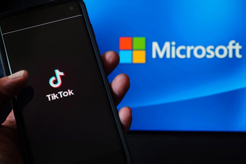 NEW YORK, NEW YORK - AUGUST 03: In this photo illustration, a mobile phone featuring the TikTok app is displayed next to the Microsoft logo on August 03, 2020 in New York City. Under threat of a U.S. ban on the popular social media app, it has been reported that Microsoft is considering taking over from Chinese firm ByteDance. (Photo Illustration by Cindy Ord/Getty Images)