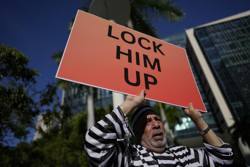 People rally outside the Wilkie D. Ferguson Jr. U.S. Courthouse, Tuesday, June 13, 2023, in Miami. Former President Donald Trump is making a federal court appearance today on dozens of felony charges accusing him of illegally hoarding classified documents and thwarting the Justice Department's efforts to get the records back.(AP Photo/Rebecca Blackwell)