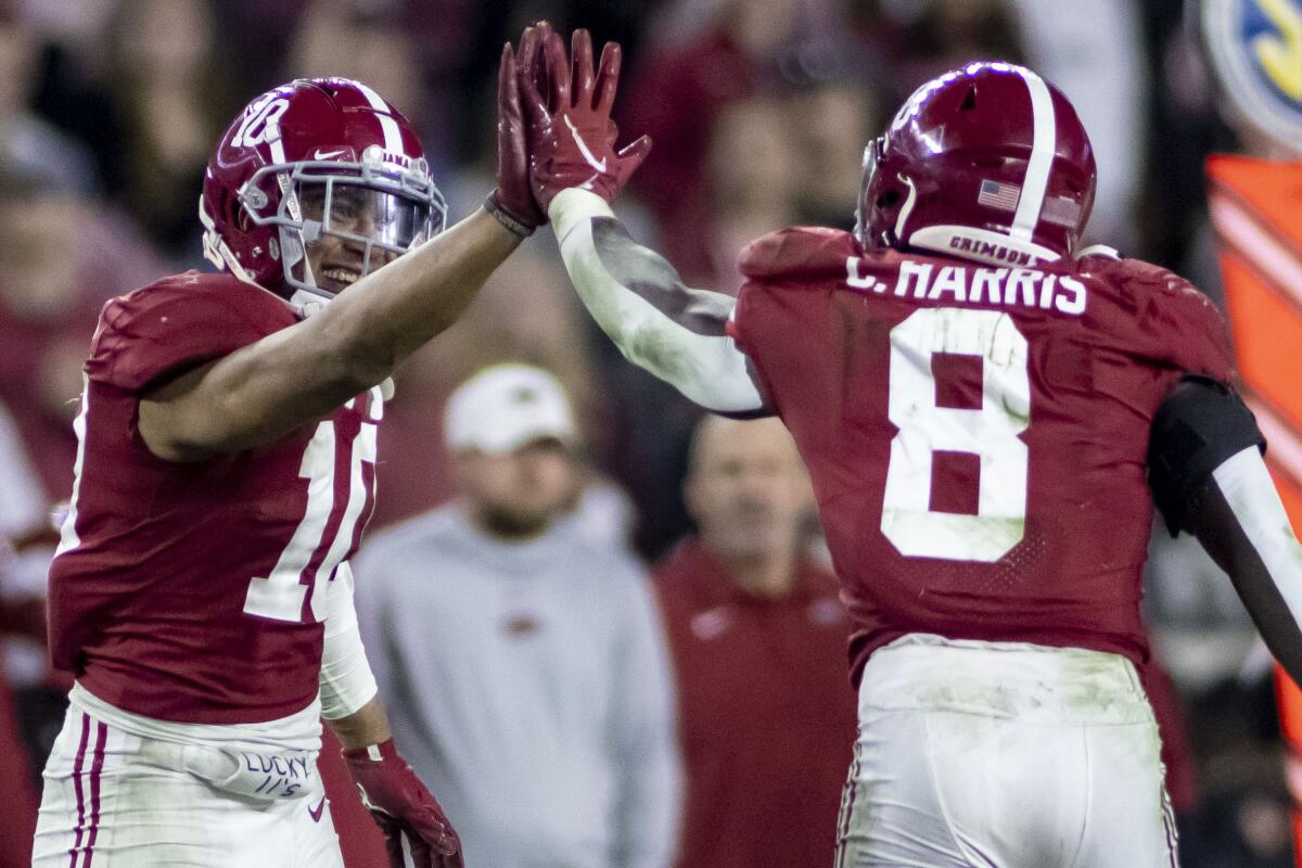 Alabama linebackers Henry To'oTo'o and Christian Harris high-five after a stop of Arkansas.