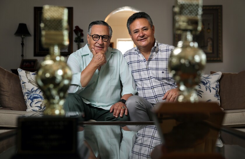 Dodger broadcaster Jaime Jarrin and his son Jorge are photographed with their Golden Mike awards.