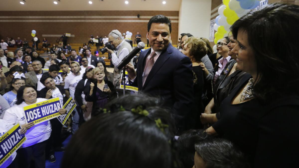 Los Angeles City Councilman Jose Huizar acknowledges his wife, Richelle Huizar, at a 2015 election night event at Bishop Mora Salesian High School.