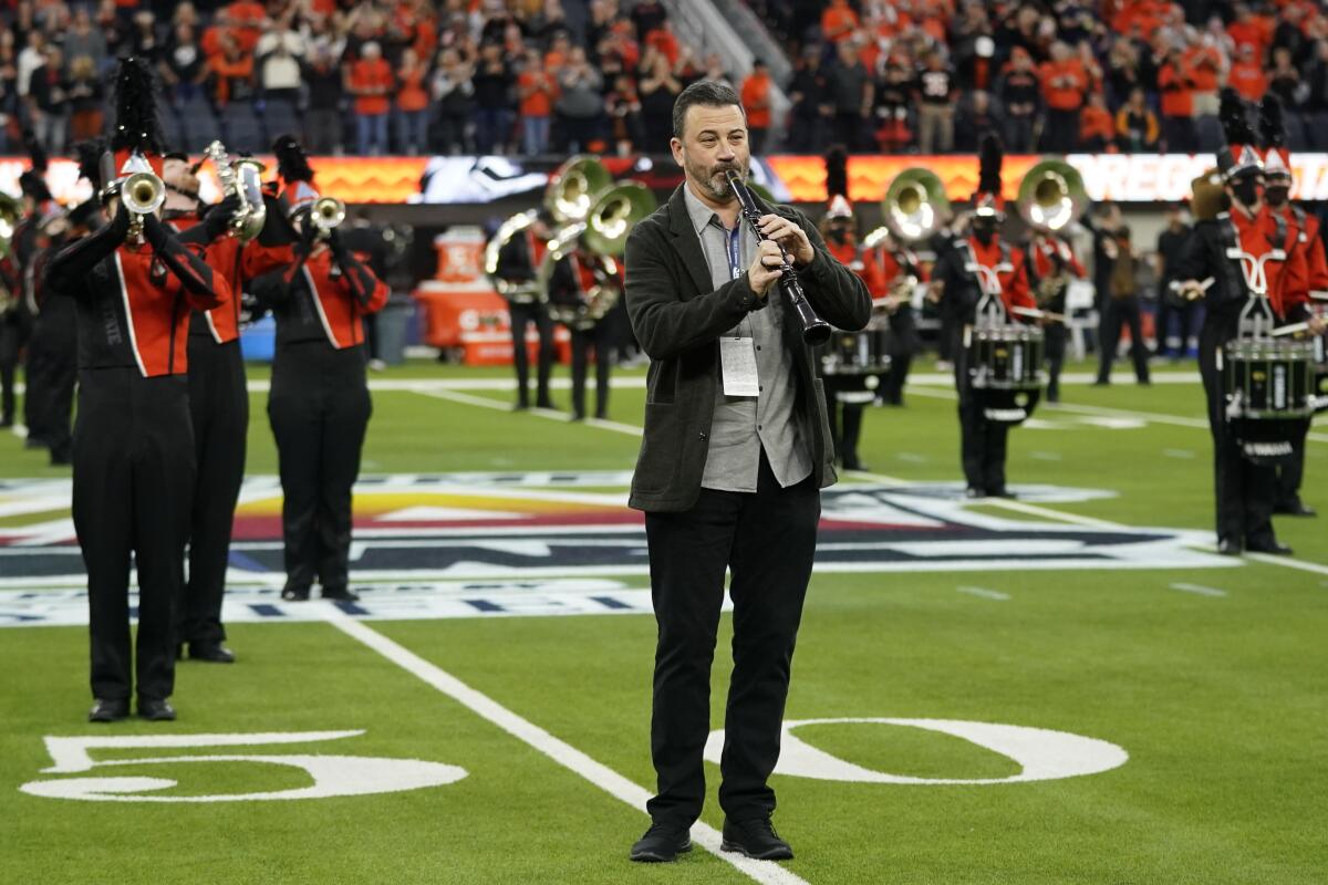 Late-night talk-show host Jimmy Kimmel plays clarinet with the Oregon State marching band Dec. 18, 2021.