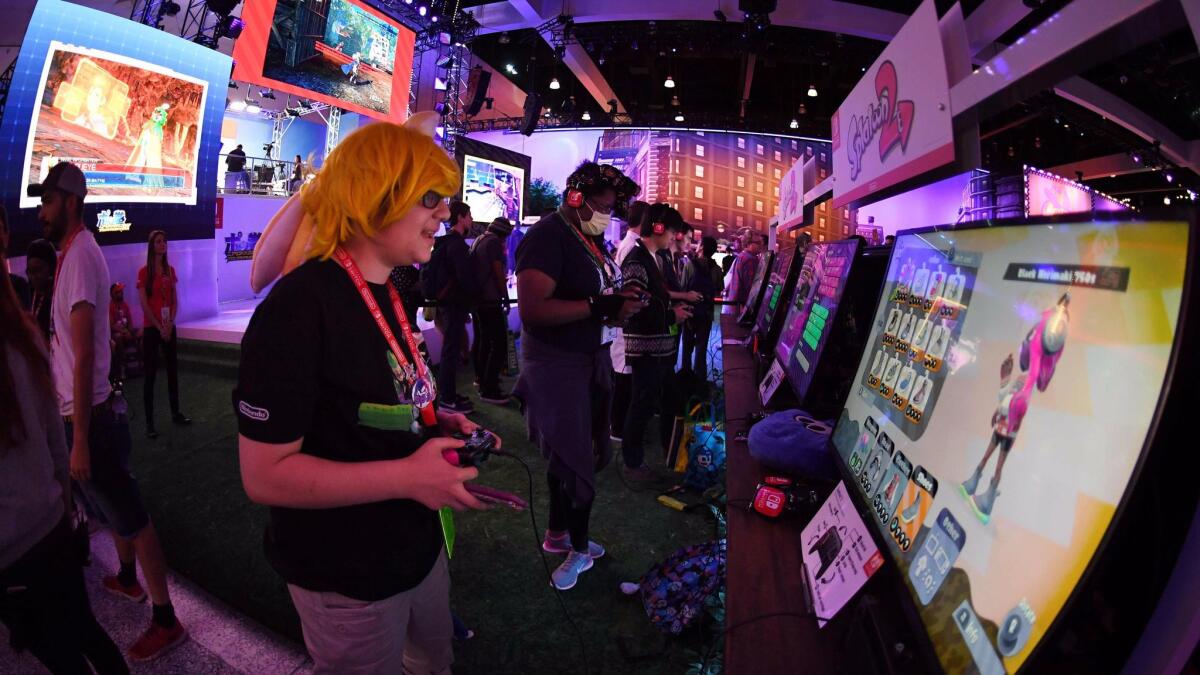 Gamers play the new Nintendo Switch console at the Los Angeles Convention Center at the three-day Electronic Entertainment Expo in June.