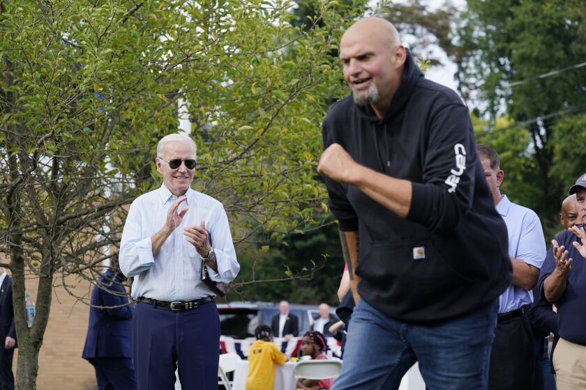 President Joe Biden watches as Democratic Pa. Lt. Gov. John Fetterman takes the stage at a United Steelworkers of America Local Union 2227 event in West Mifflin, Pa., Monday, Sept. 5, 2022, to honor workers on Labor Day. (AP Photo/Susan Walsh)