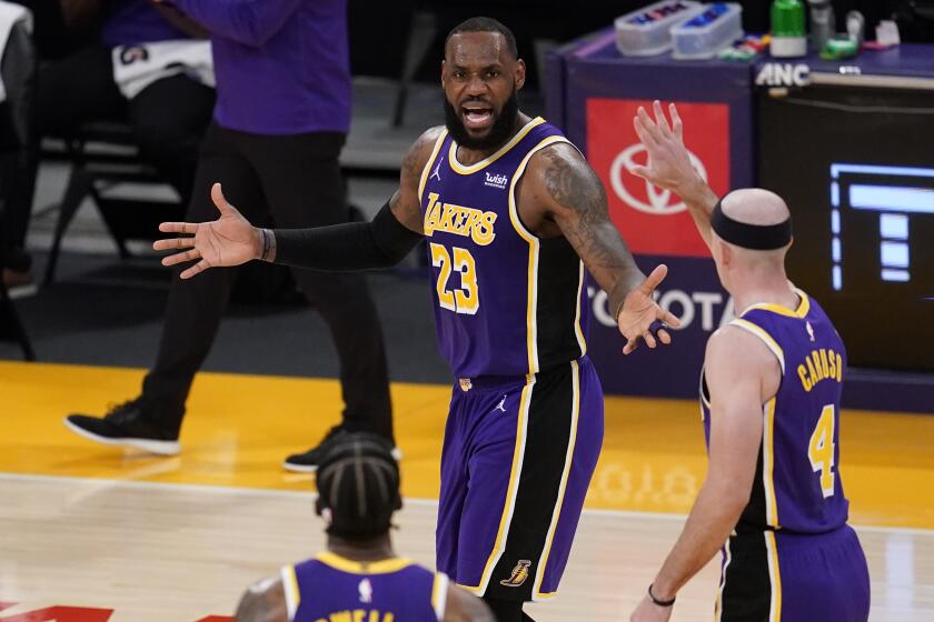 Los Angeles Lakers forward LeBron James (23) talks to teammates during the second half of an NBA basketball game against the Charlotte Hornets Thursday, March 18, 2021, in Los Angeles. (AP Photo/Marcio Jose Sanchez)