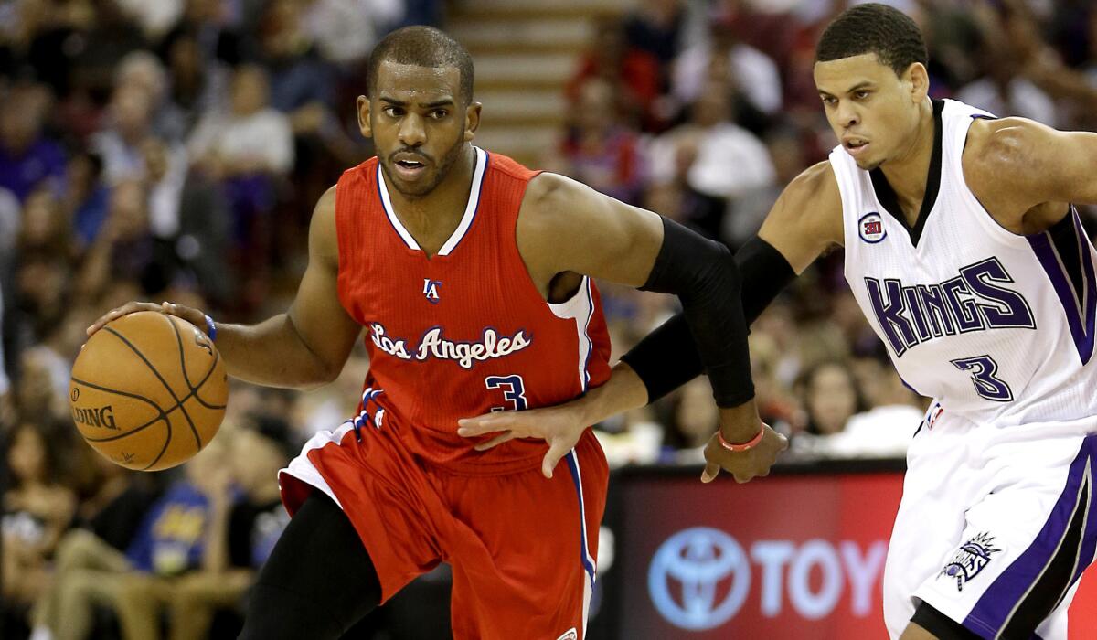 Clippers point guard Chris Paul, who finished with 30 points and 11 assists, drives past Kings guard Ray McCallum in the second half Wednesday night at Staples Center.