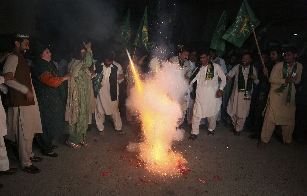 Supporters of Pakistani opposition party hold firework to celebrate following the Supreme Court decision, in Peshawar, Pakistan, Thursday, April 7, 2022. Pakistan's Supreme Court on Thursday blocked Prime Minister Imran Khan's bid to stay in power, ruling that his move to dissolve Parliament and call early elections was illegal. That set the stage for a no-confidence vote by opposition lawmakers, who say they have enough support to oust him. (AP Photo/Muhammad Sajjad)