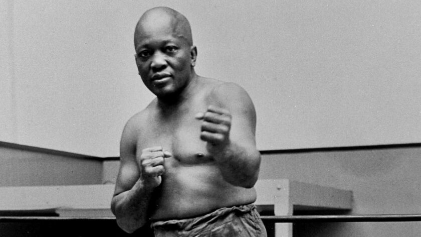 Boxer Jack Johnson, the first black world heavyweight champion, poses in New York City in 1932.