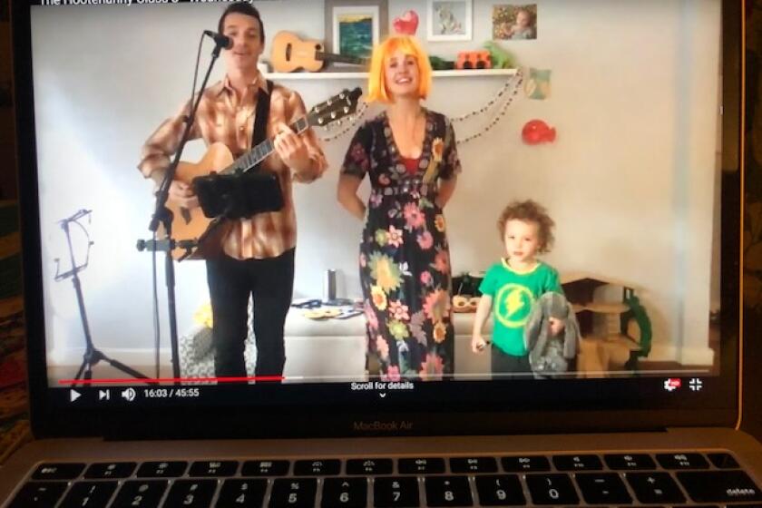 Lauren O'Brien, Matt Commerce and their son Miles, during an early episode of their new virtual music class, "The Hootenanny."