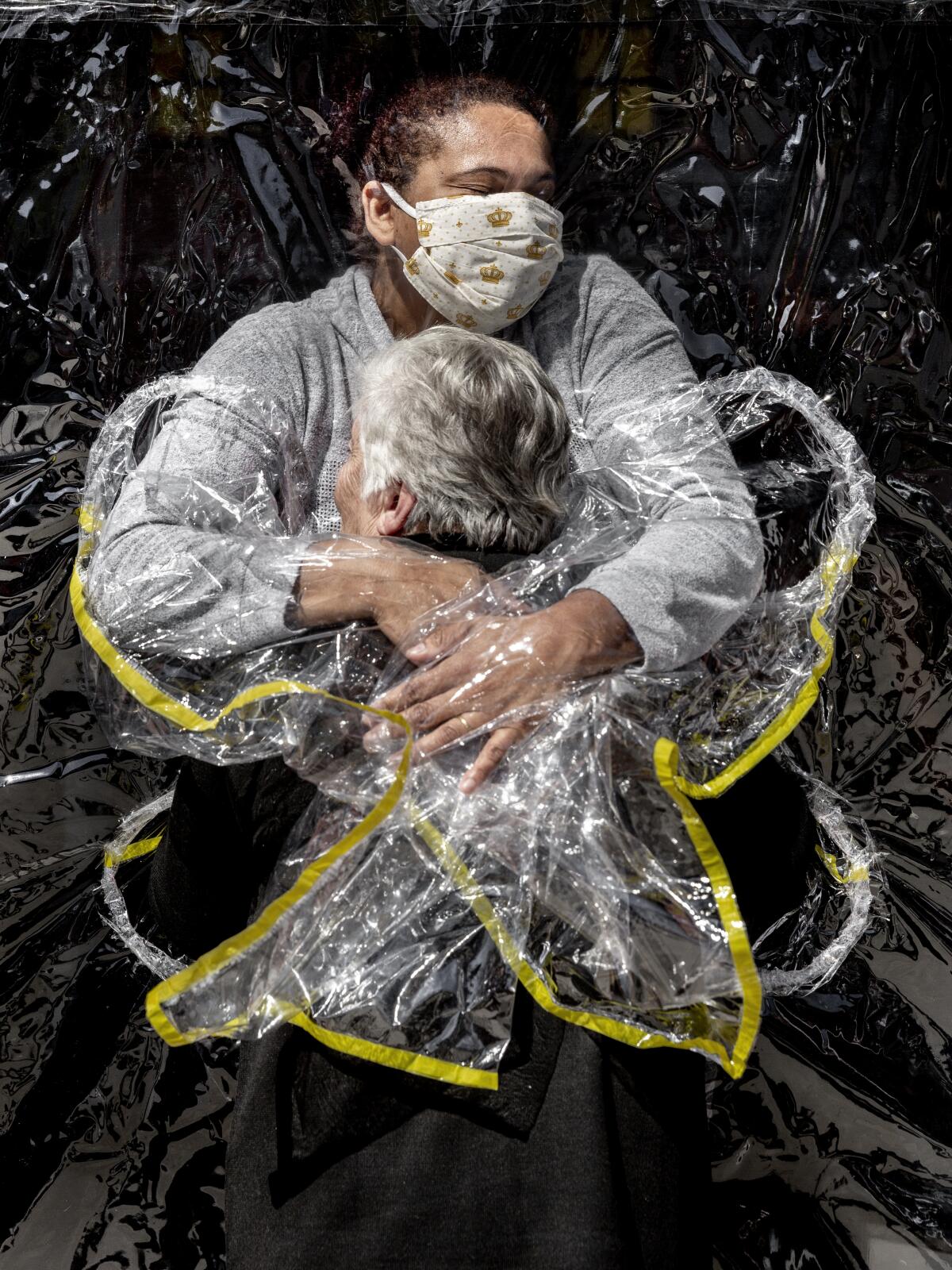 In this image released by World Press Photo, Thursday April 15, 2021, by Mads Nissen, Politiken, Panos Pictures, which won the World Press Photo of the Year award, and the first prize in the General News Singles category, titled The First Embrace, shows Rosa Luzia Lunardi (85) embraced by nurse Adriana Silva da Costa Souza, at Viva Bem care home, Sao Paulo, Brazil, on August 5, 2020. (Mads Nissen, Politiken, Panos Pictures, World Press Photo via AP)