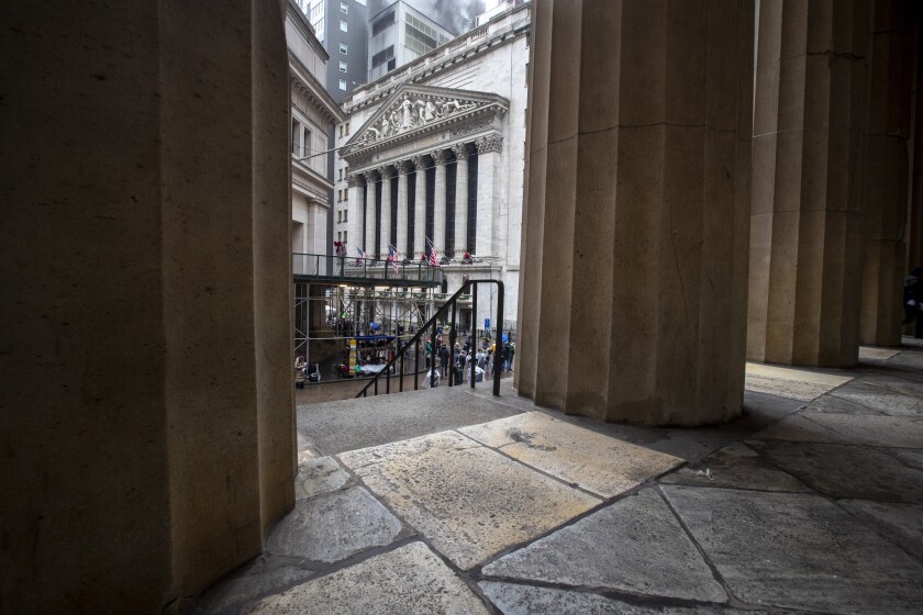 The New York Stock Exchange is framed by the columns at Federal Hall National Memorial in New York