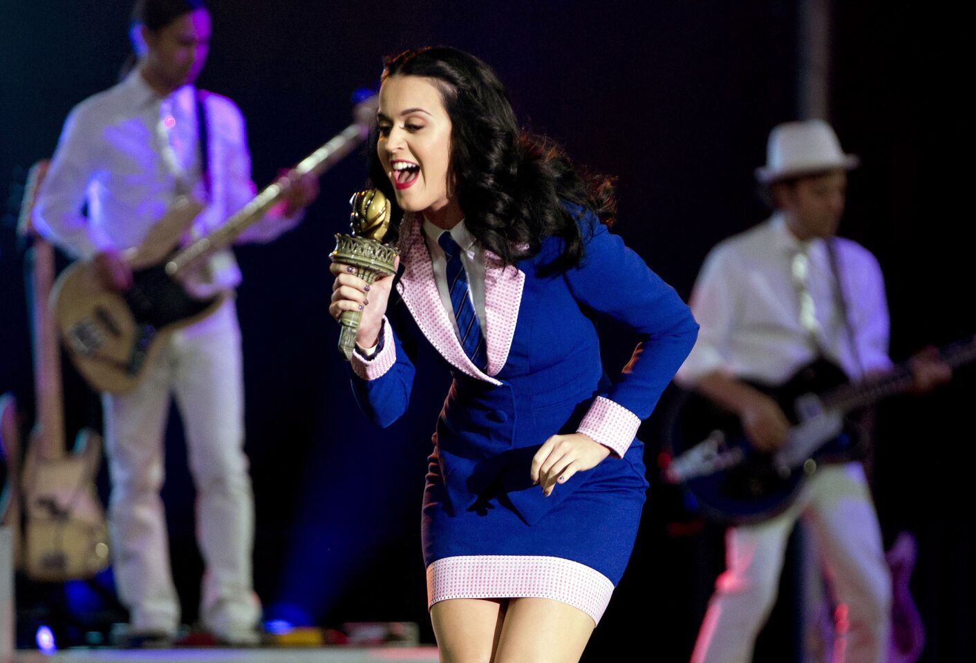 Katy Perry delivers a song for a crowd before the arrival of President Barack Obama at a campaign rally in October 2012.