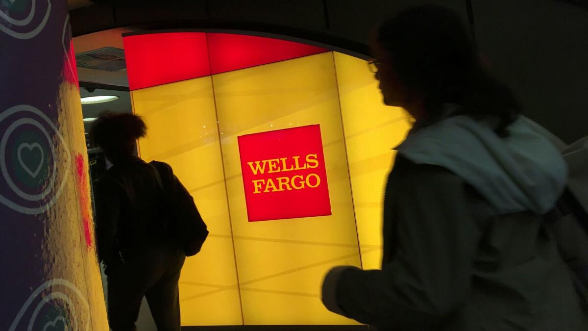 Commuters walk by a Wells Fargo ATM location at New York's Penn Station on Oct. 13, 2016.