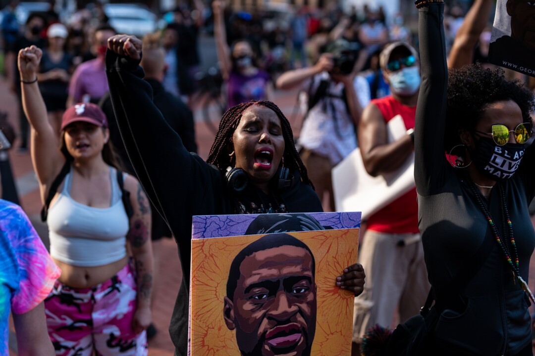 Ifran Aden, 41, of Minneapolis shouts as Toshira Garraway speaks during the inaugural remembrance rally.