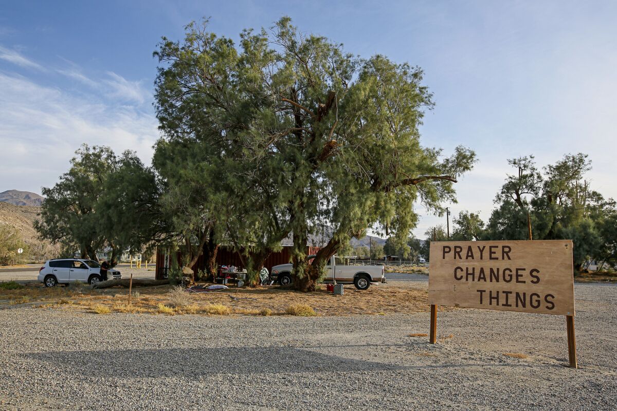 Fred Byrd and Kay Byrd, displaced by the earthquake, are living with two daughters and one granddaughter under a tree along Trona Road. (Irfan Khan / Los Angeles Times)