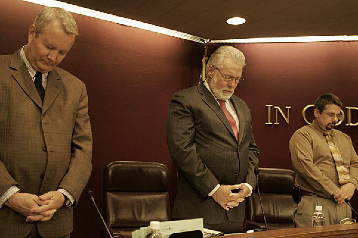 Lancaster Mayor R. Rex Parris, center, leads the opening prayer at a City Council meeting in 2011.