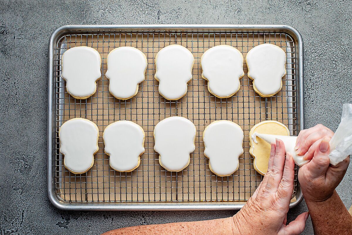 The unstamped cookies get flooded with royal icing, providing a blank canvas to paint designs onto.