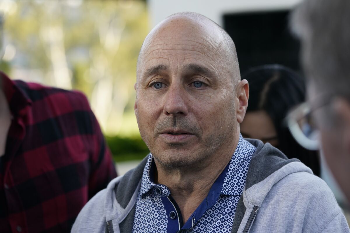 New York Yankees general manager Brian Cashman talks with reporters during Major League Baseball's general managers meetings Tuesday, Nov. 9, 2021, in Carlsbad, Calif. (AP Photo/Gregory Bull)