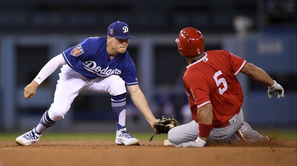 Los Angeles Dodgers second baseman Enrique Hernandez, left, tags out Albert Pujols at second on March 26.