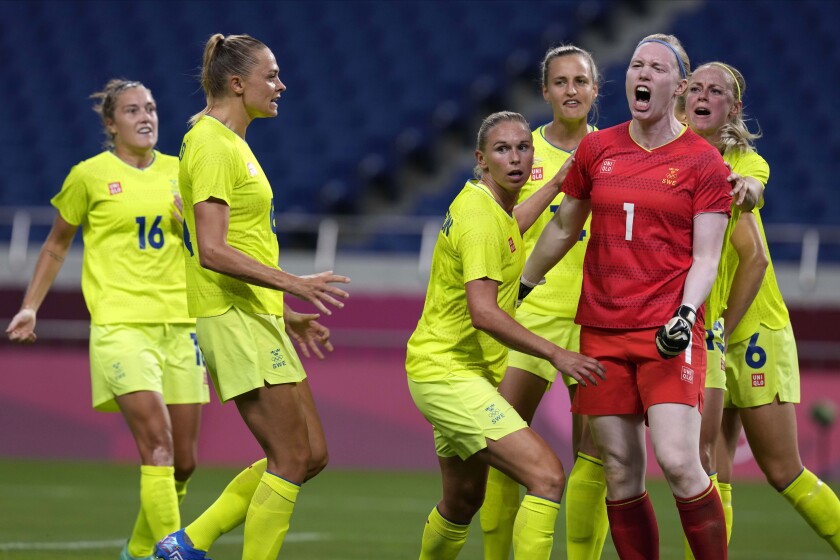 Sweden's goalkeeper Hedvig Lindahl (1) reacts as she celebrates with her teammates after stopping a penalty kick by Australia during a women's soccer match at the 2020 Summer Olympics, Saturday, July 24, 2021, in Saitama, Japan. (AP Photo/Martin Mejia)