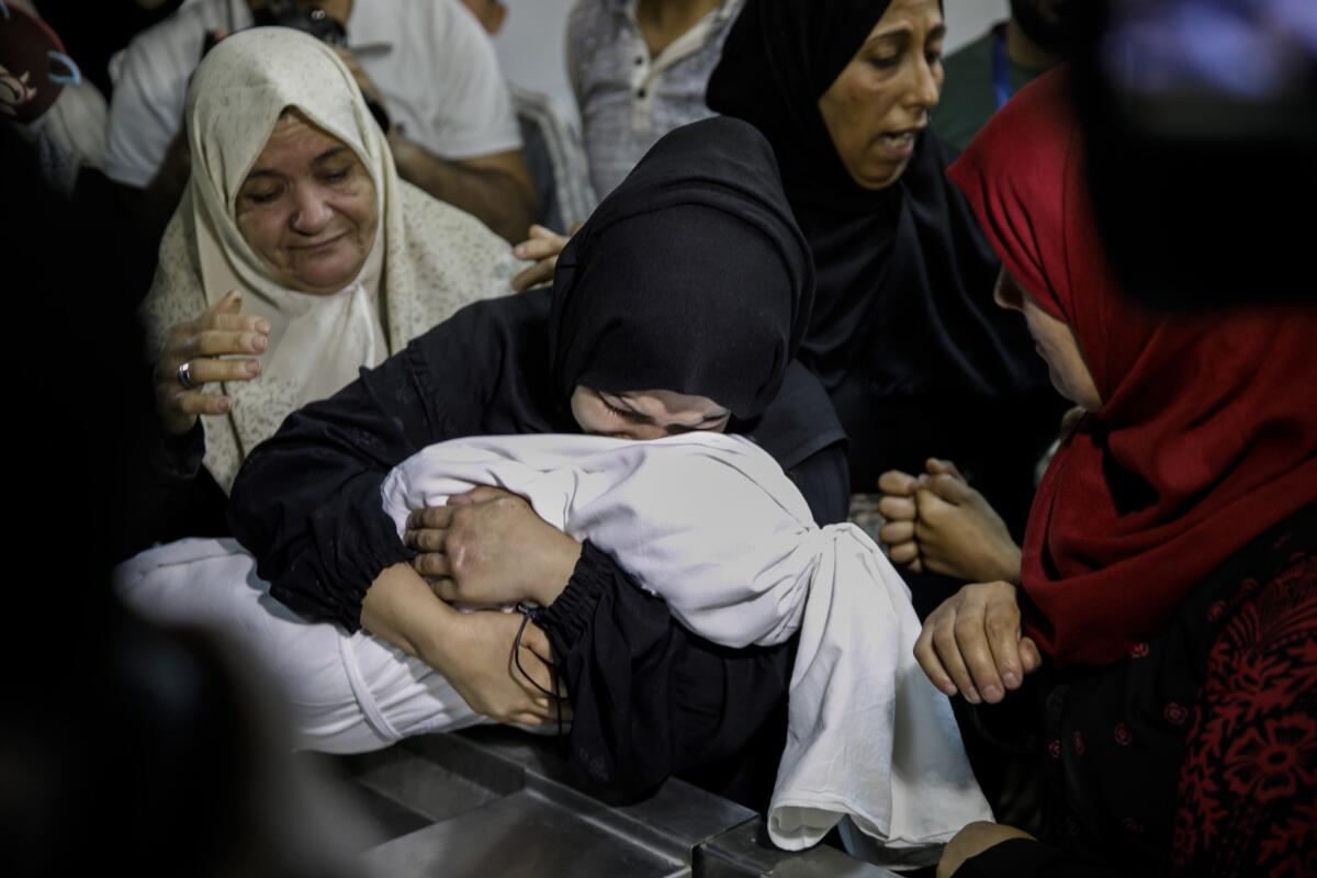 Mariam Ghandour, 18, holds the body of her daughter Layla. Her family says the 10-month-old died after being exposed to tear gas in the Gaza Strip. A doctor says she had a preexisting heart condition.