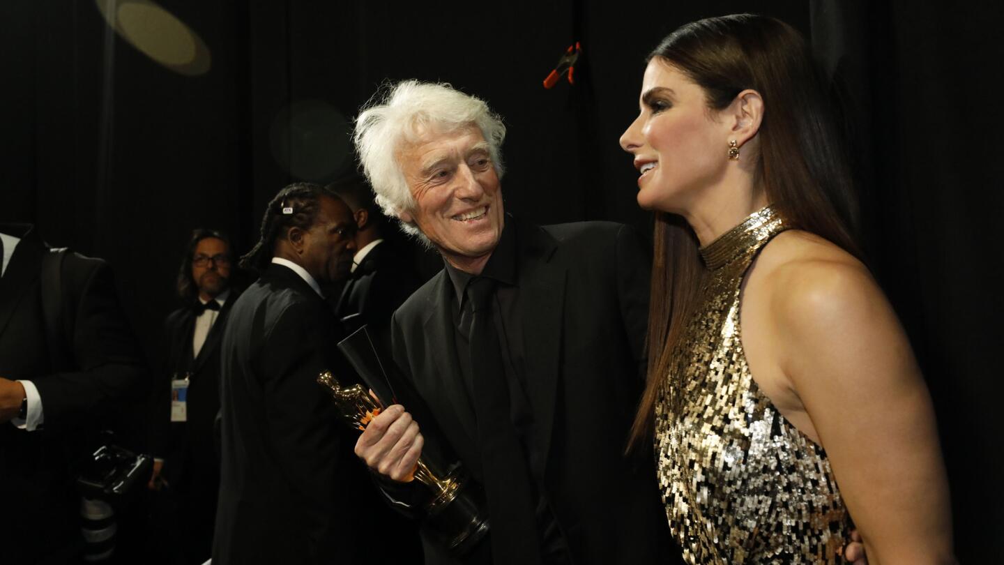 Roger Deakins, after winning for cinematography for "Blade Runner 2049," with presenter Sandra Bullock backstage at the 90th Academy Awards on Sunday at the Dolby Theatre in Hollywood.