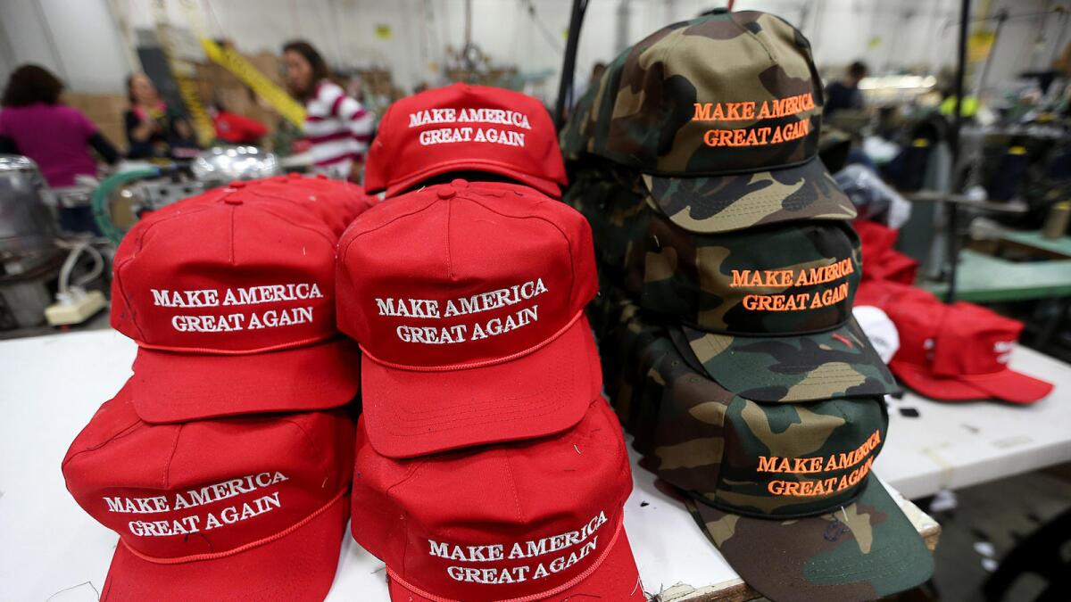 “Make America Great Again” baseball caps sit on a table in a factory.