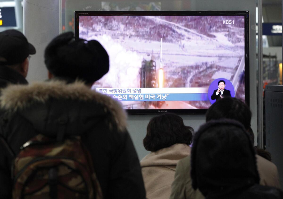 Video of North Korea's Dec. 12 launch of a multistage rocket plays on a monitor at a Seoul railway station Thursday. The launch, which placed a satellite in orbit, was considered a test of North Korea's intercontinental ballistic missile technology.