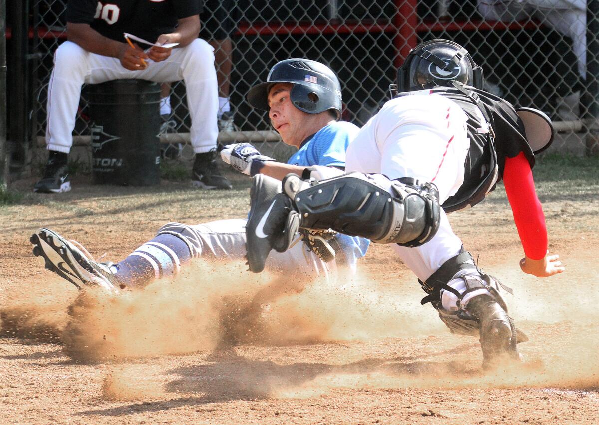 Crescenta Valley's Michael Russo slides safely home to score against Glendale's Hank Drosdik in a Pacific League baseball game at Glendale High School on Tuesday, April 8, 2014. Crescenta Valley won the game 4-0.