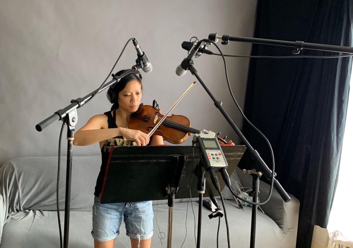 Violinist Melissa Tong recording music at home.