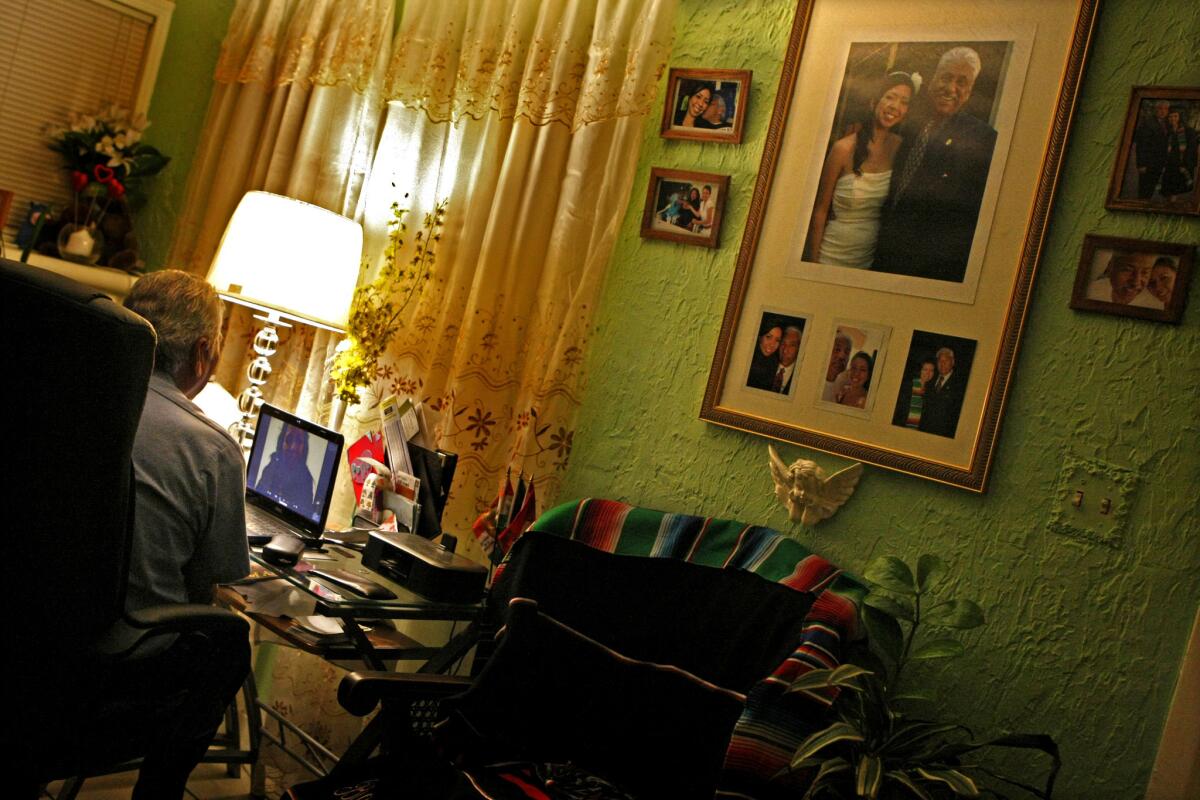Gerardo Herrejon talks to Ana in his home, which the Glendale bus driver has decorated with photographs of the couple.